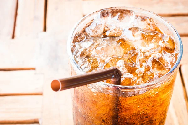 Fresh cola drink with ice on wood table — Stock Photo, Image