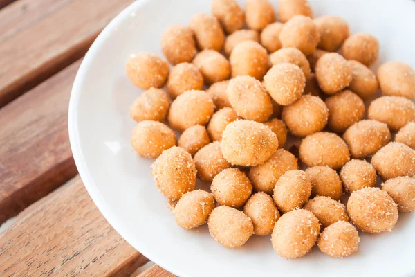 Close up of spicy peanuts snack on white dish — Stock Photo, Image