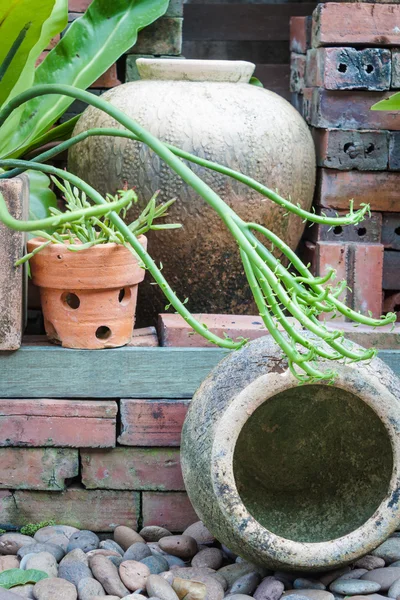 Apart of garden decorated with earthen jar — Stock Photo, Image