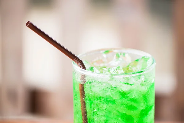 Close up ice cubes on green drink — Stock Photo, Image