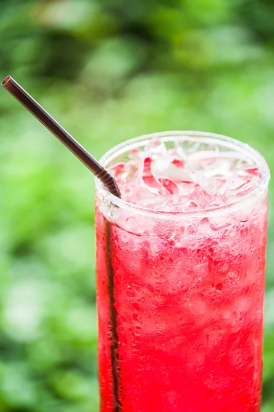Refreshing time with glass of cold red drink — Stock Photo, Image