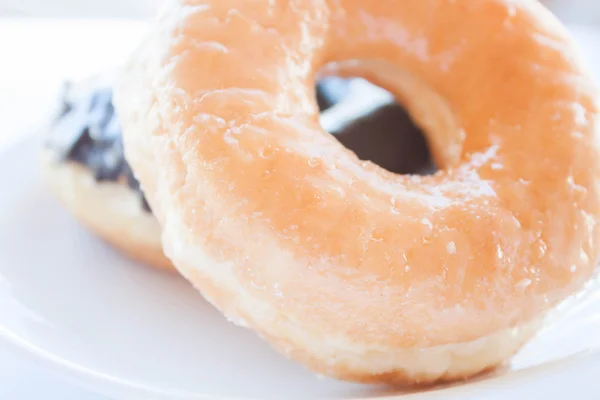 Sugar and chocolate donuts on white dish — Stock Photo, Image