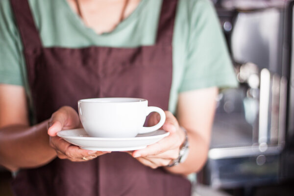 Barista serving freshly brewed coffee 