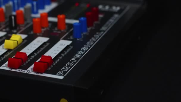 Sound engineer raises two red volume faders with two fingers close-up — Stock Video