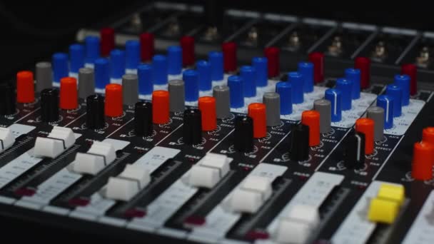 Ingeniero de sonido gira un potenciómetro en una consola de mezcla de audio profesional — Vídeos de Stock