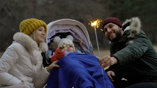 Baba, anne ve küçük kız bayramı sokakta maytaplarla kutluyorlar.
