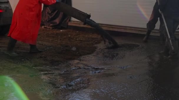 Worker pouring concrete at the construction site. Concrete unloading - close up — Stock Video