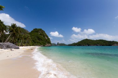 Dalgalar kayalar ve kum üzerine.