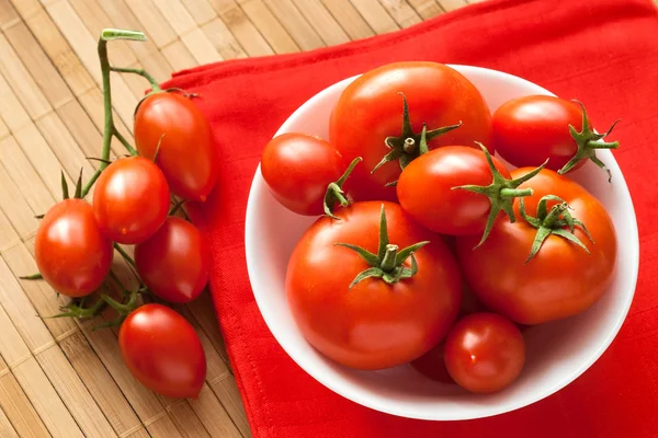 Tomatoes on red — Stock Photo, Image