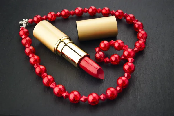 Lipstick and heart shape jewelry — Stock Photo, Image
