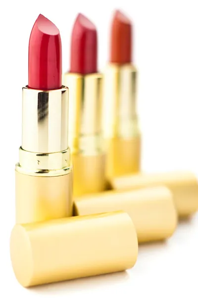 Tres lápices labiales rojos — Foto de Stock