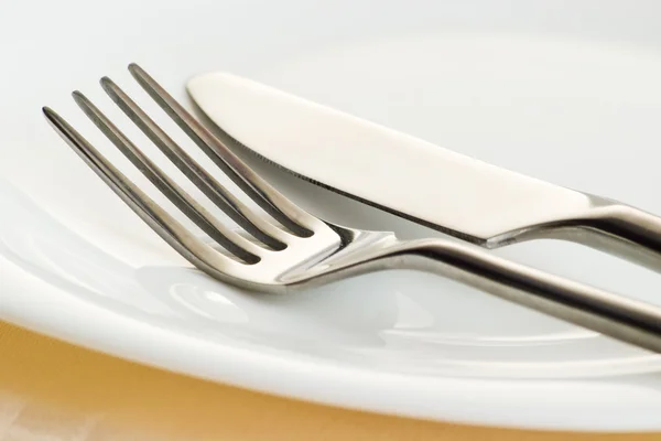 Fork and knife on plate — Stock Photo, Image