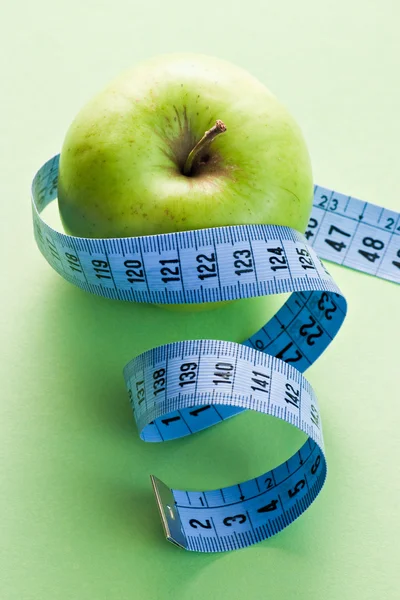 Apple with blue measuring tape — Stock Photo, Image