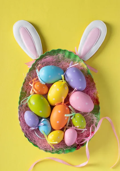 Easter Colorful Eggs Plate Egg Bunny Ears Yellow Background Vertical — Stock Photo, Image