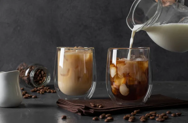 Two Glasses Cold Coffee Ice Cubes Which Milk Poured Dark — Stockfoto