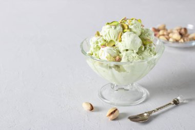 Şeffaf cam kasede fındıklı fındıklı dondurma, gri arka planda dondurma, boşluğu kopyala