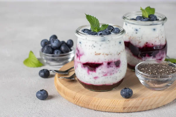 Chia Pudding Blueberry Jam Two Glass Jars Wooden Board Light — 图库照片