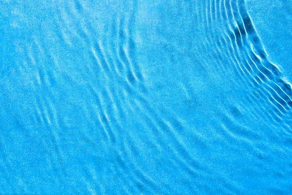 the calm rippling water from the top right corner texture in baby blue color. a background pattern of the clear liquid water for creative design.