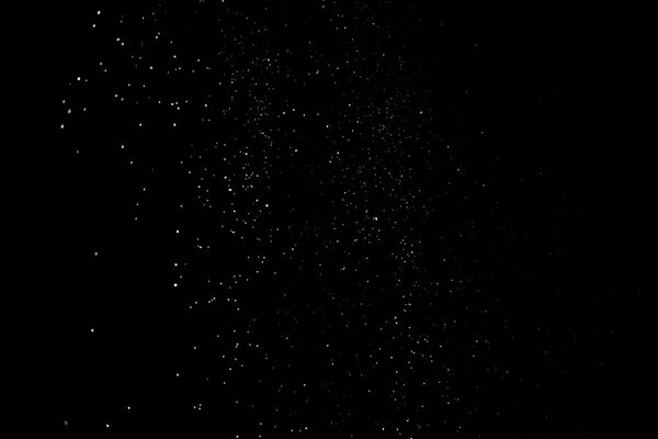 Animation of the white particles on black background representing a snowfall. Snow overlay footage for giving a freezing or winter effect to the video presentation.