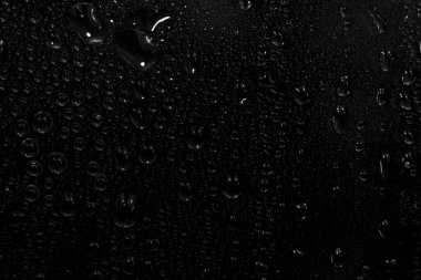 Su damlaları siyah arkaplanda. Fotoğraf kaplama efekti için pencere camındaki çiğ damlacıkları ya da içecek modelleri üzerinde taze etki yaratmak için.