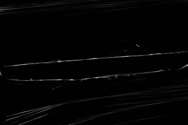 Прозрачная Пластиковая Пленка Отверстием Черном Фоне Реалистичная Рваная Текстура Полиэтиленовой — стоковое фото