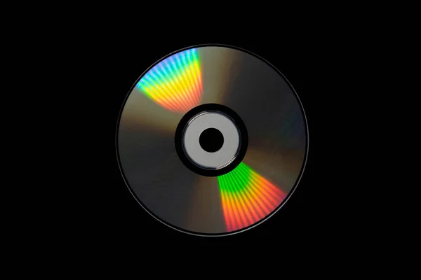 cd or dvd, storage data information technology. music and movie record. holographic side of the compact disc. a compact disc isolated on black background.