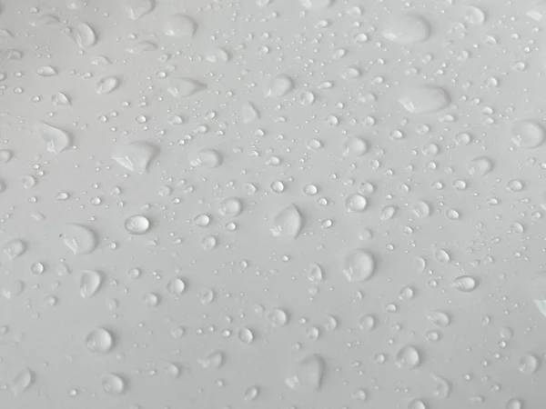 Water droplets on a white background. For background about drizzling rain with natural drops.