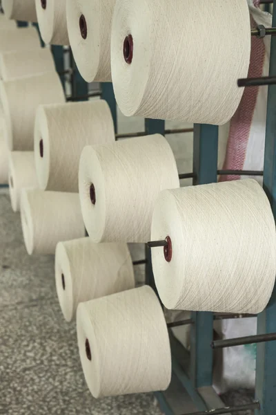 Cotton reels stacked in racks — Stock Photo, Image