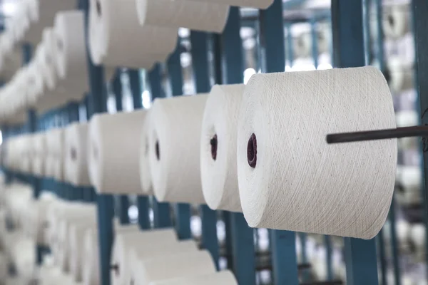 Cotton reels stacked in racks — Stock Photo, Image