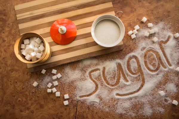 Masadaki yazı şekeri, şeker kasesindeki rafine şeker..