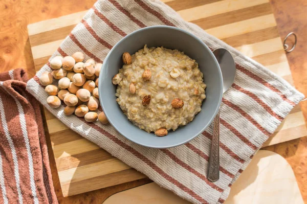 Healthy Dietary Nutritious Oatmeal Hazelnuts Gray Plate Table Top View — Stock Photo, Image