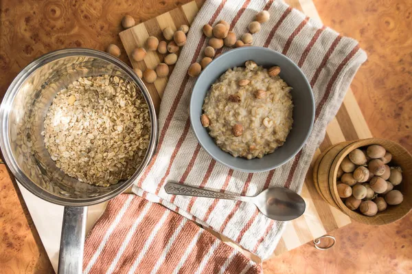 Healthy Dietary Nutritious Oatmeal Hazelnuts Gray Plate Table Top View — Stock Photo, Image