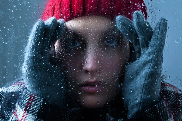 Woman Peeking Through a Wet Glass — Stock Photo, Image