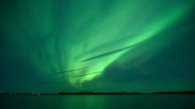 Kuzey İsveç 'te göl kenarında yeşil kuzey ışıklarının yer değiştirmesi