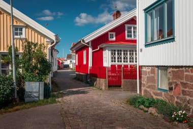 Alley with colorful houses in the village of Molloesund on the archipelago island of Orust on the west coast of Sweden, sunny day with blue sky