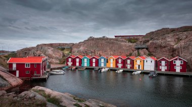 Bay with colorful boathouses and boats in Smoegen on the west coast of Sweden