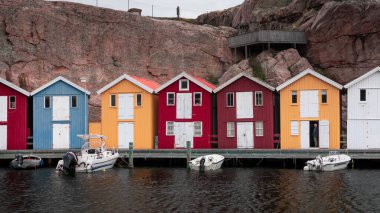 Bay with colorful boathouses and boats in Smoegen on the west coast of Sweden