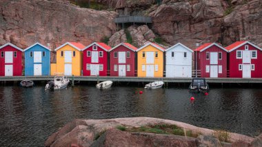 Bay with colorful boathouses and boats in Smoegen on the west coast of Sweden