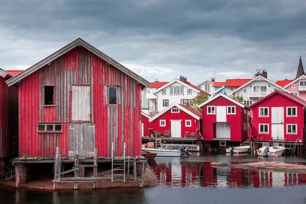 Bay with red boathouses and boats in Smoegen on the west coast of Sweden