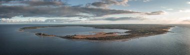 Coast and lighthouse Lange Erik on north coast of the island of Oland in the east of Sweden from above during sunset