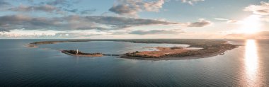 Coast and lighthouse Lange Erik on north coast of the island of Oland in the east of Sweden from above during sunset