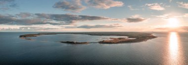 Coast and lighthouse Lange Erik on north coast of the island of Oland in the east of Sweden from above during sunset