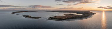 Coast and lighthouse Lange Erik on north coast of the island of Oland in the east of Sweden from above during sunset