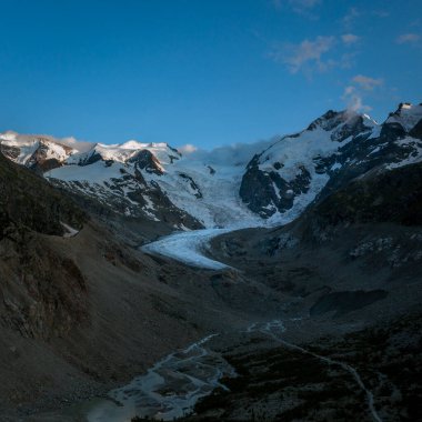 Morteratsch Buzulu, yazın İsviçre Alplerinde Engadin 'de karlı dağlar, güneş ve mavi gökyüzü.