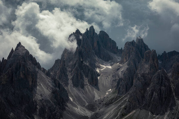 Mountain peaks in the Dolomite Alps in South Tyrol with dramatic cloudy sky, Three Peaks Nature Reserve, Italy