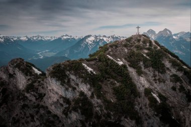 People at summit of Zunterkopf at Lake Plansee with mountains in Tyrol Austria during sunny blue sky weather from above