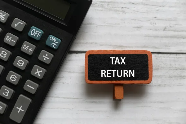 Top View Calculator Red Tag Written Tax Return White Wooden — Foto de Stock
