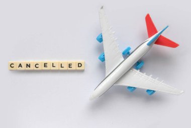 Top view of toy plane or flight with a text of cancelled.