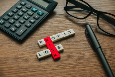 Business concept. Alphabetical crossword of Profit, Loss and Risk.