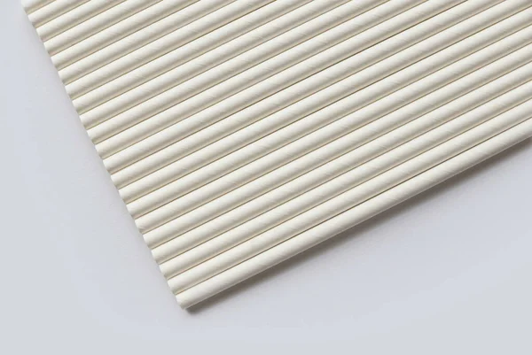 A row of biodegradable eco friendly white paper drinking straw isolated on white background